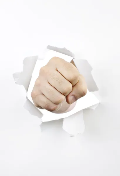 Fist punching through hole in paper — Stock Photo, Image