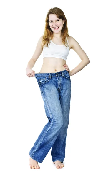 Happy girl in jeans after losing weight — Stock Photo, Image