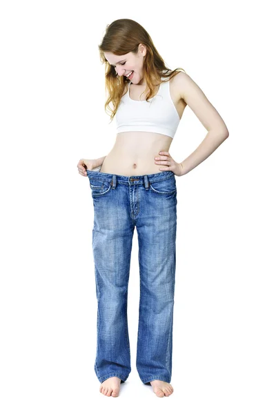 快乐的女孩在牛仔裤后减肥 — 图库照片