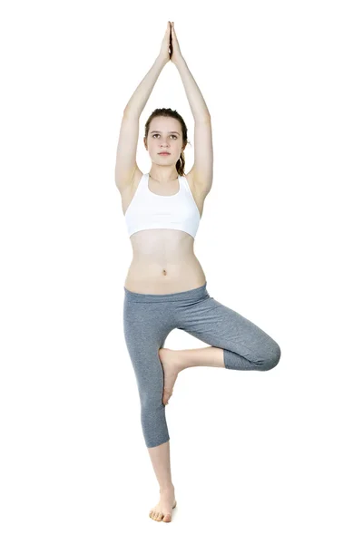 Fit girl doing tree yoga pose — Stock Photo, Image