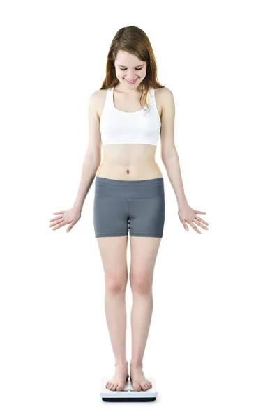 Fit young girl checking her weight — Stock Photo, Image