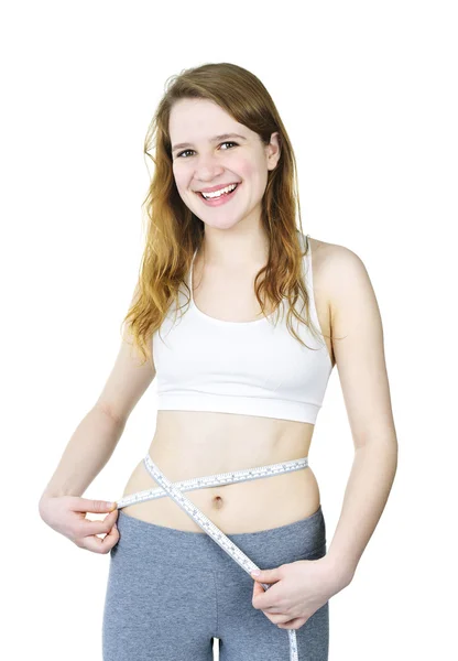 Feliz jovencita midiendo su cintura — Foto de Stock