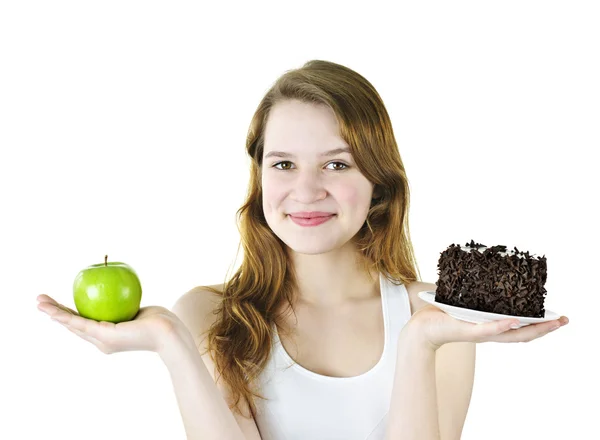 Menina segurando maçã e bolo — Fotografia de Stock
