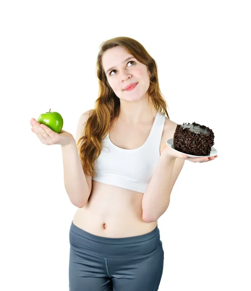 Chica joven sosteniendo manzana y pastel —  Fotos de Stock