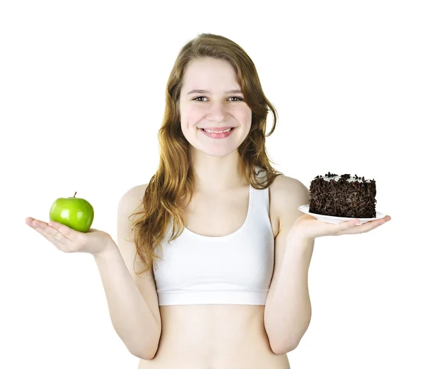 Giovane ragazza in possesso di mela e torta — Foto Stock