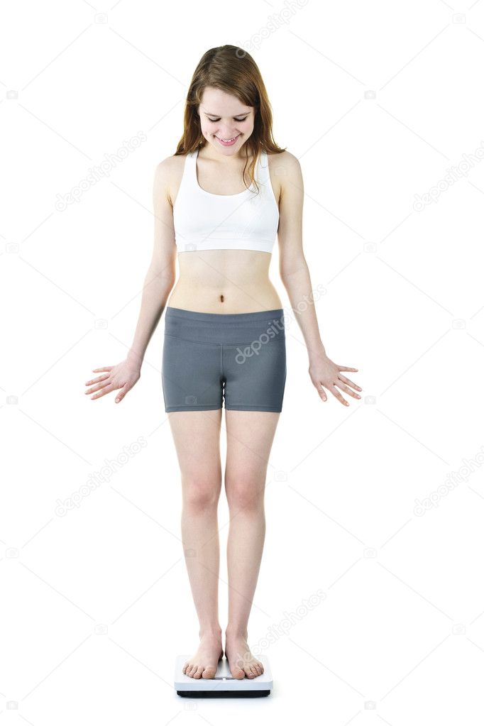 Fit young girl checking her weight