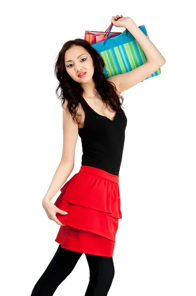 Asiatic young women in skirt with shopping bags, isolated — Stock Photo, Image
