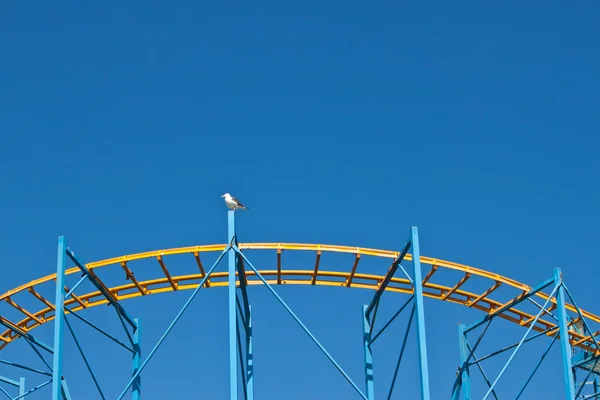 Fairground roller caoster ride with blue sky — Stock Photo, Image