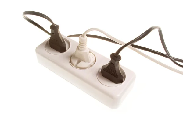 stock image Three electrical plugs into the outlet