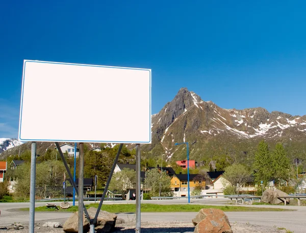 Big white billboard in the background of rocky mountains — Stock Photo, Image