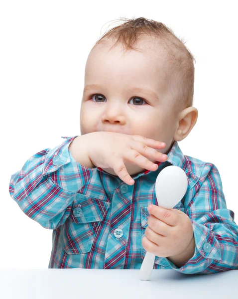 Cute little boy is biting his finger — Stock Photo, Image