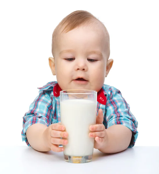 Cute little boy is holding big glass of milk — Stock Photo, Image