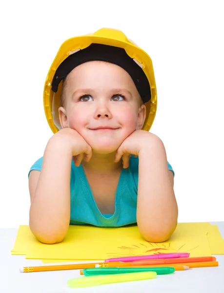 Cute little girl is playing while wearing hard hat — Stock Photo, Image