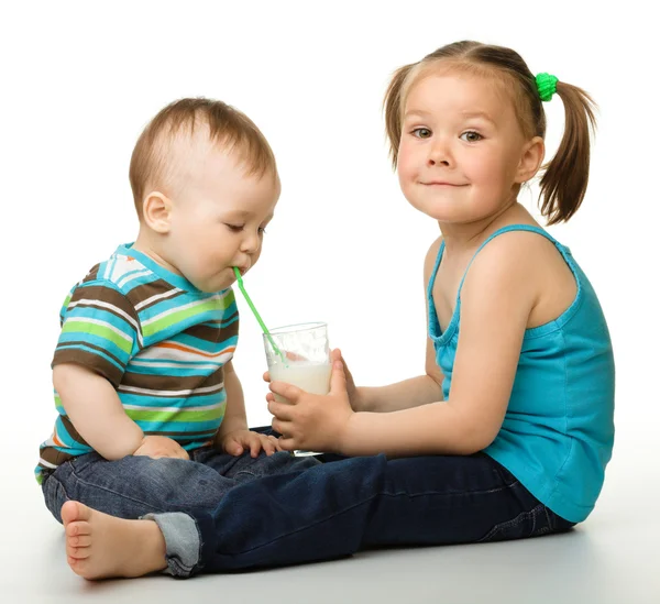 Sister is feeding her little brother — Stock Photo, Image