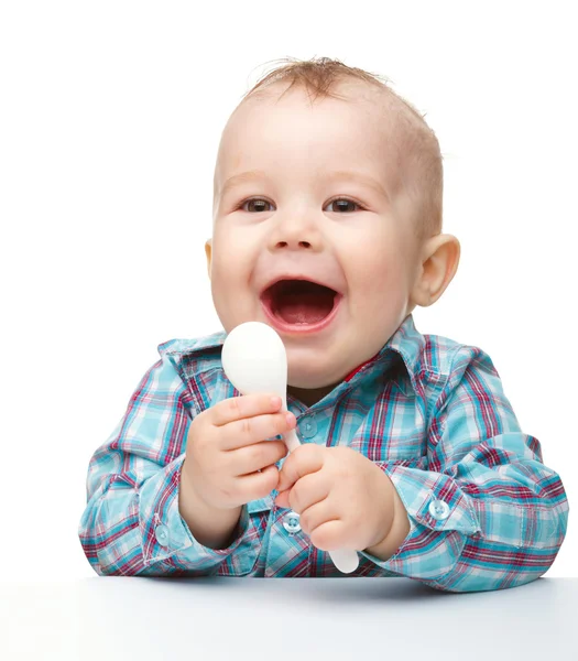 Cute little boy with white spoon — Stock Photo, Image
