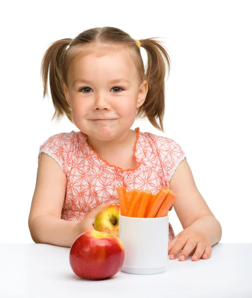Carino bambina mangia carote e mele — Foto Stock