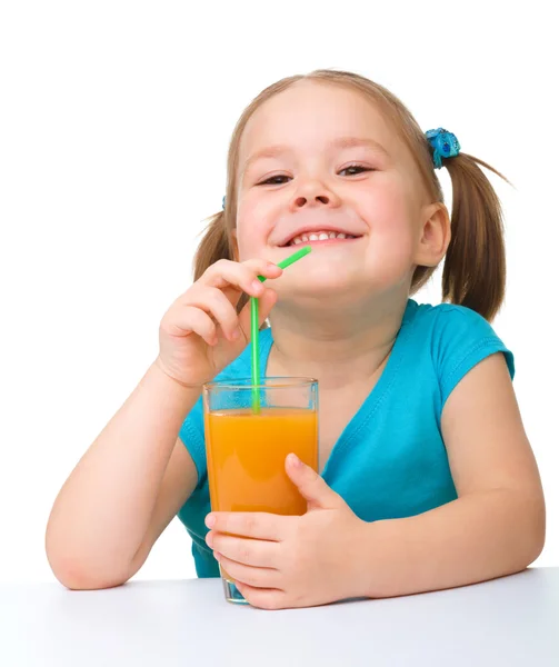 Little girl drinks orange juice — Stock Photo, Image
