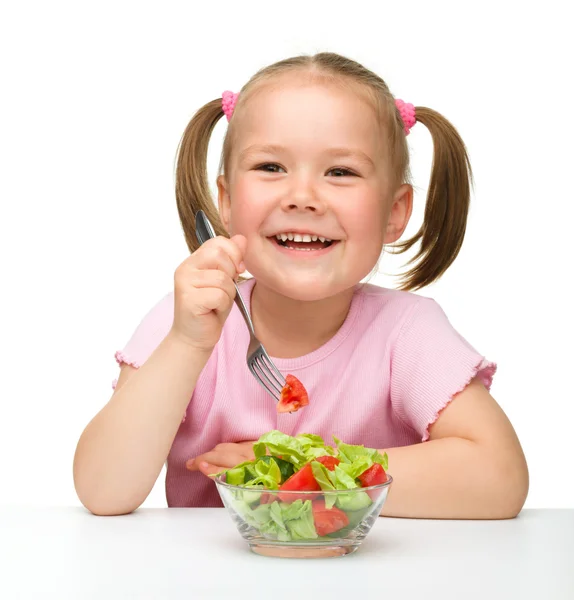 Cute little girl eats vegetable salad — Stock Photo, Image