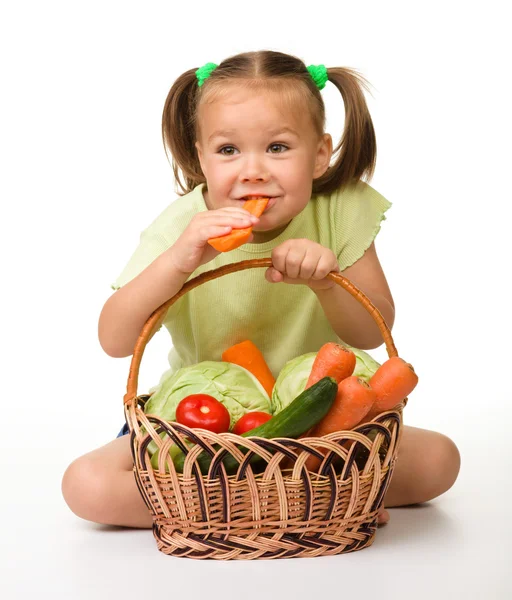 Милая маленькая девочка ест морковь. — стоковое фото