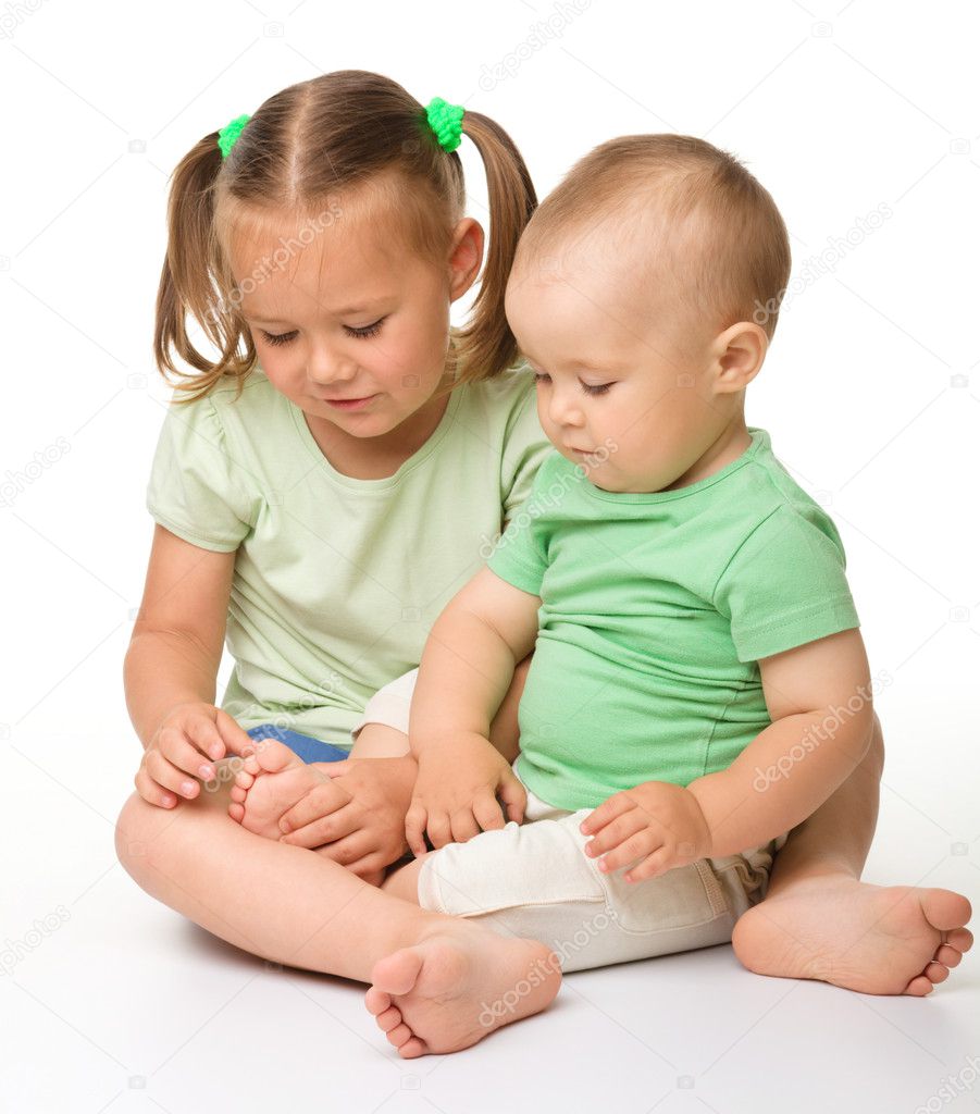 Two children are playing on the floor