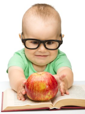 Little child is playing with red apple clipart