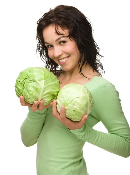 Beautiful young girl with two green cabbages — Stock Photo, Image