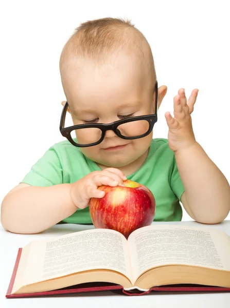 stock image Little child is playing with red apple