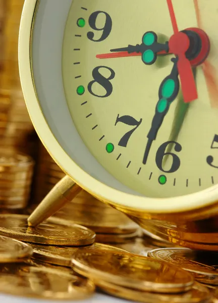 Il tempo è denaro - quadrante dell'orologio e monete d'oro — Foto Stock