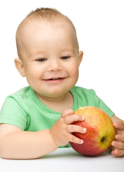 Kleines Kind beißt in roten Apfel — Stockfoto
