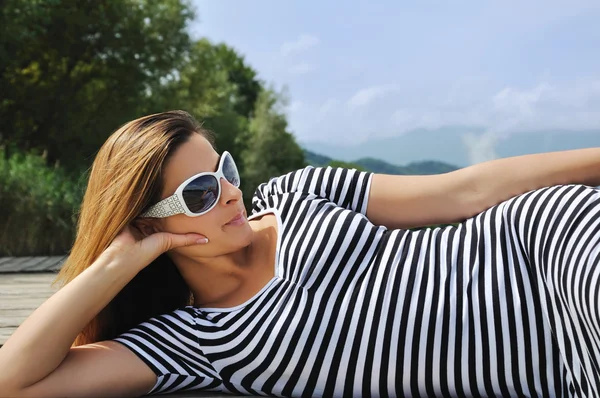 stock image Attractive woman lying on the wood ground