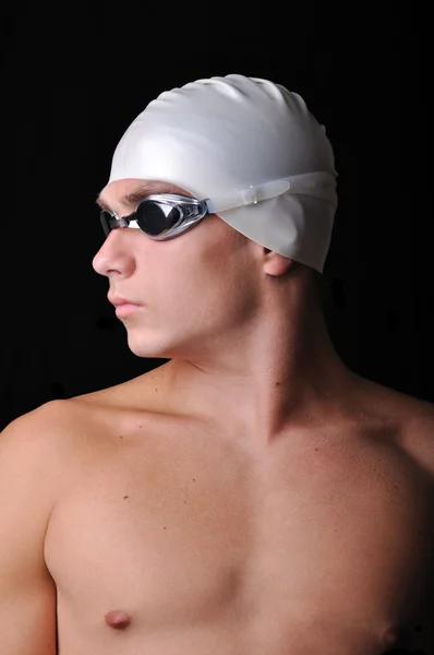 Mand svømmer isoleret i sort - Stock-foto