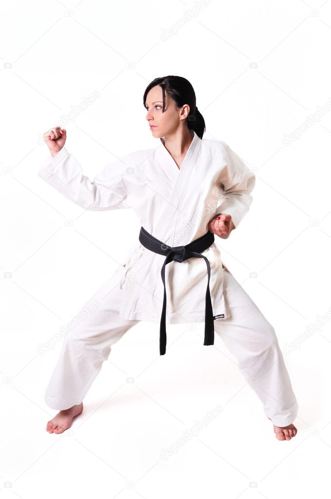 Karate woman in defence position isolated on white