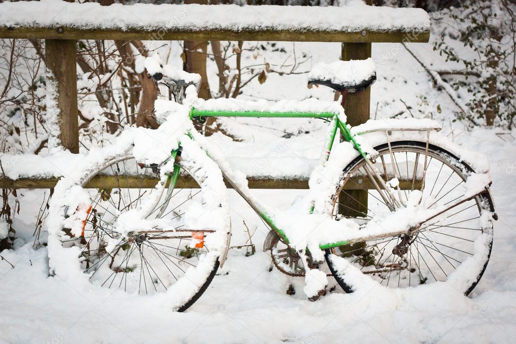 Bicycle under pack of snow