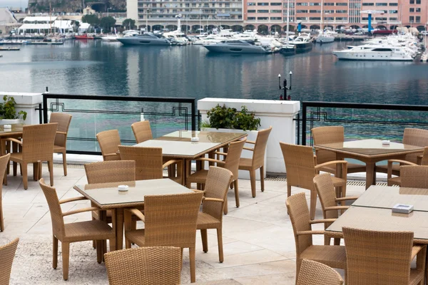 Restaurant terrace overlooking yacht harbor Stock Photo