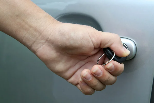 stock image Young girl open shes gray car