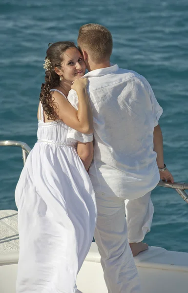 Newly married couple stood on the bow of a boat — Stock Photo, Image