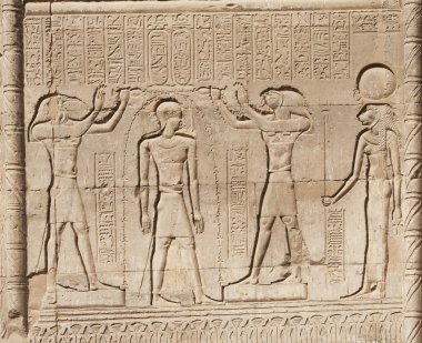 Hieroglyphic carvings on an Egyptian temple wall clipart