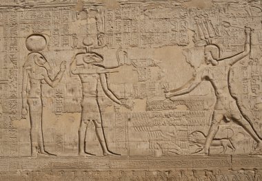 Hieroglyphic carvings on an Egyptian temple wall clipart