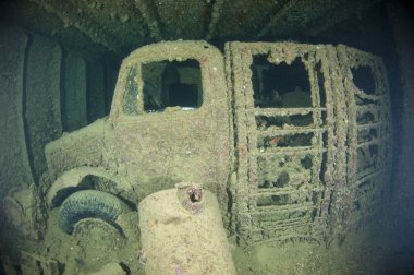 Truck inside the hold of a large shipwreck clipart