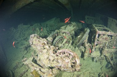 Motorbikes inside a large shipwreck clipart