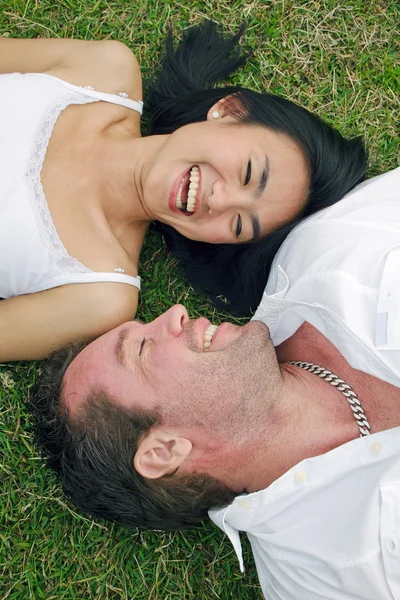 stock image Couple lying on lawn