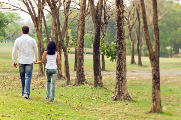 Couples walk hand in hand Royalty Free Stock Images