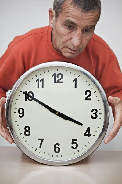 Man holding clock between his hands — Stock Photo, Image