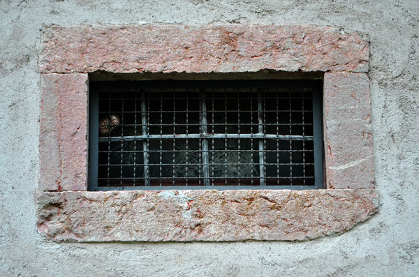 Window with iron bars and broken glass