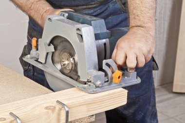 Carpenter with circular saw clipart
