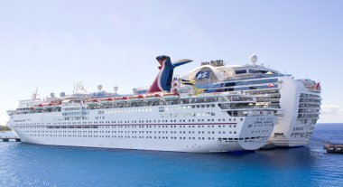 Two large cruise ships tied to pier clipart