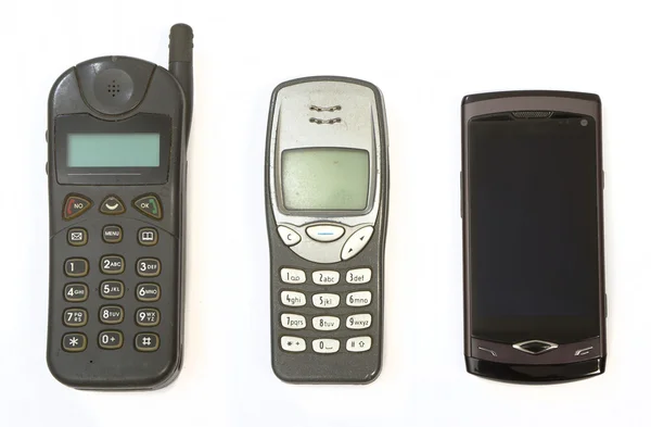 Мобільні телефони трьох поколінь — стокове фото