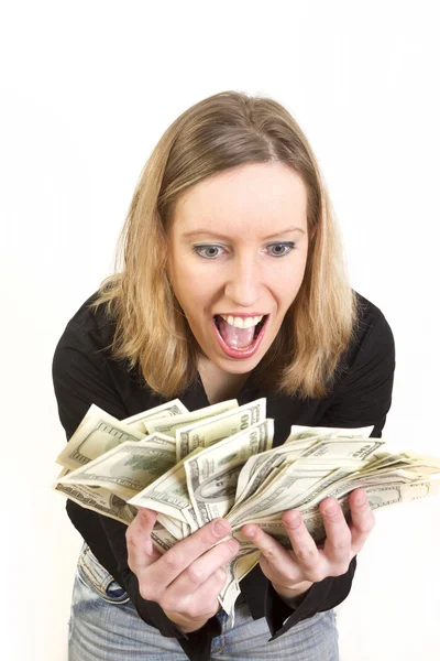Jovem mulher tem lotes de dólares em suas mãos e olhar feliz — Fotografia de Stock