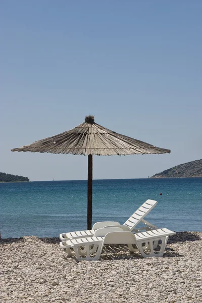 stock image Beach umbrella and chairs on the beach