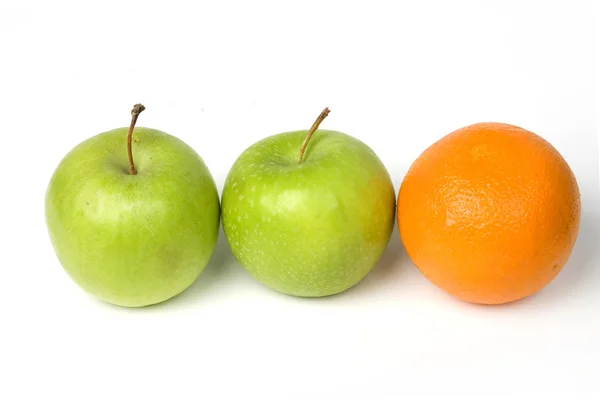 stock image Two green apples and one orange